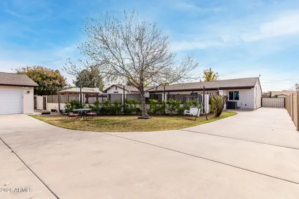 a view of pool of water with houses in big yard