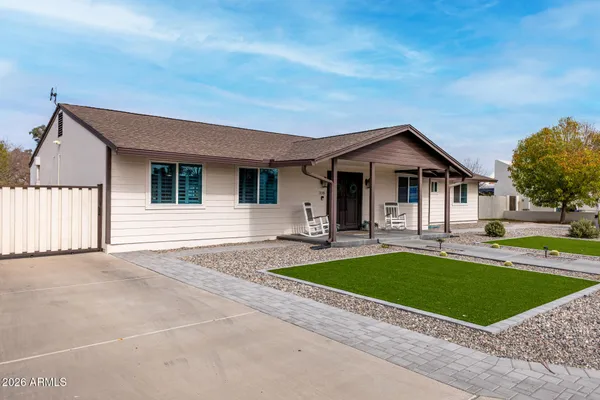 a view of a house with swimming pool and a yard