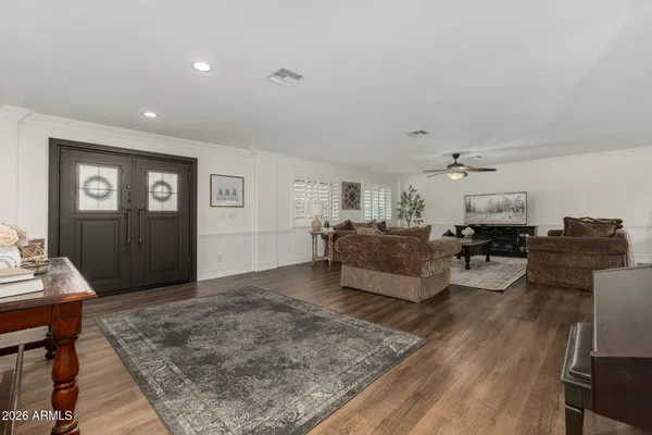 a living room with furniture and wooden floor