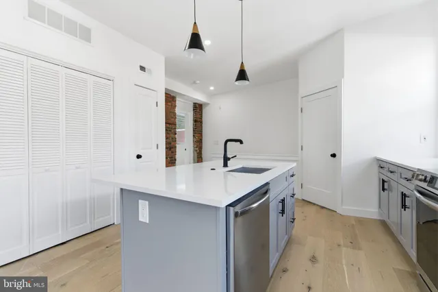 a view of a kitchen counter space a sink and appliances