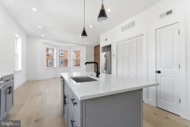 a kitchen with a sink a counter space and appliances