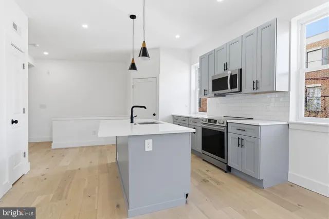 a kitchen with a sink stove and microwave