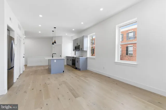 a view of kitchen with a sink cabinets and window