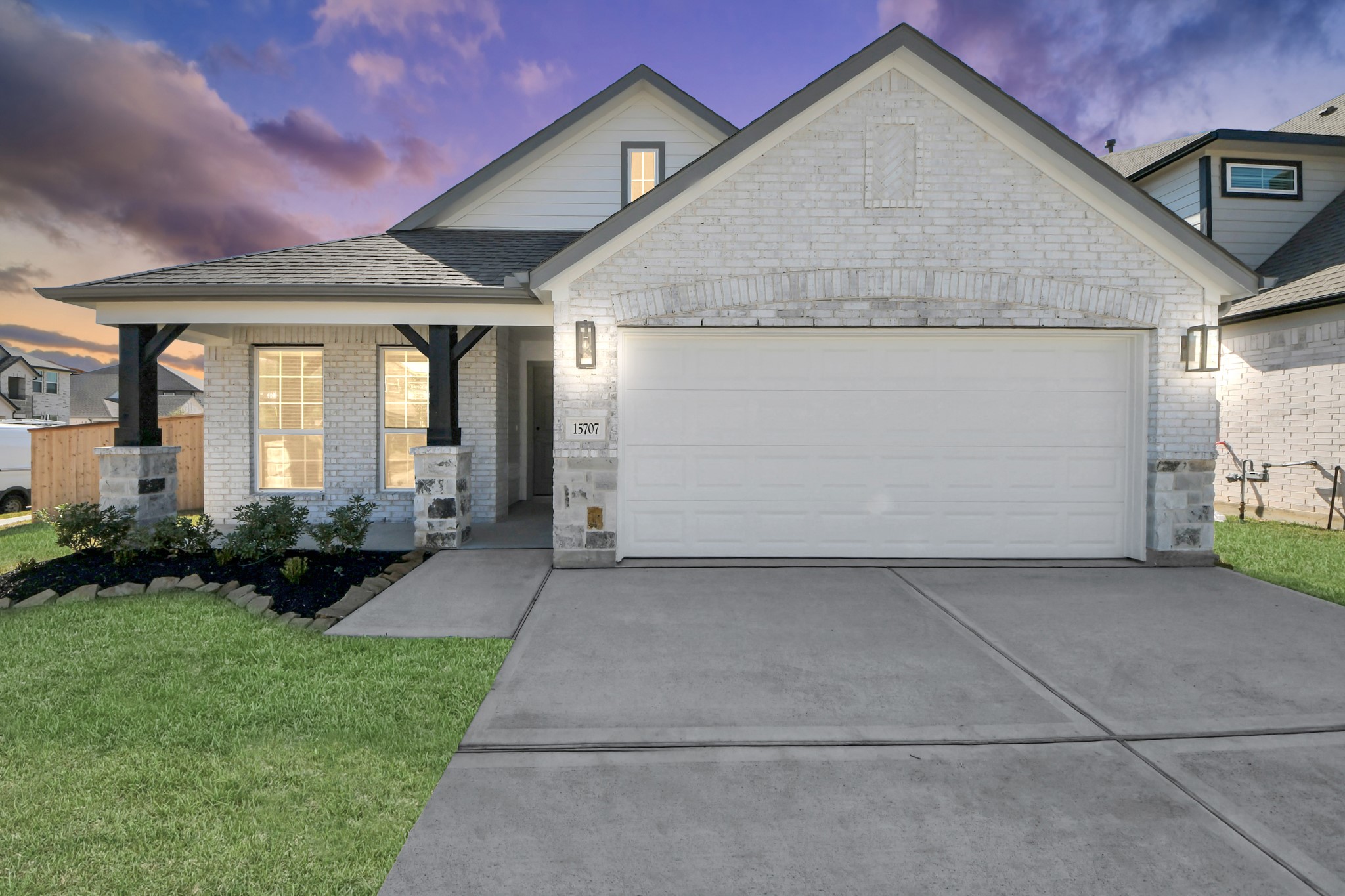 a view of a house with a small yard and plants