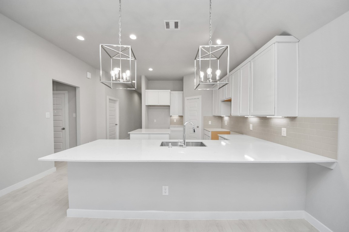 15707 Telge Ridge Lane Cypress, TX 77429 - Photo 22 of 38 a large white kitchen with kitchen island stainless steel appliances a sink and cabinets