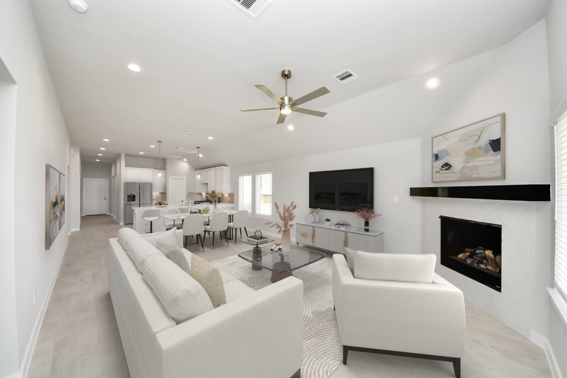 15707 Telge Ridge Lane Cypress, TX 77429 - Photo 25 of 38 a living room with furniture a fireplace and a flat screen tv