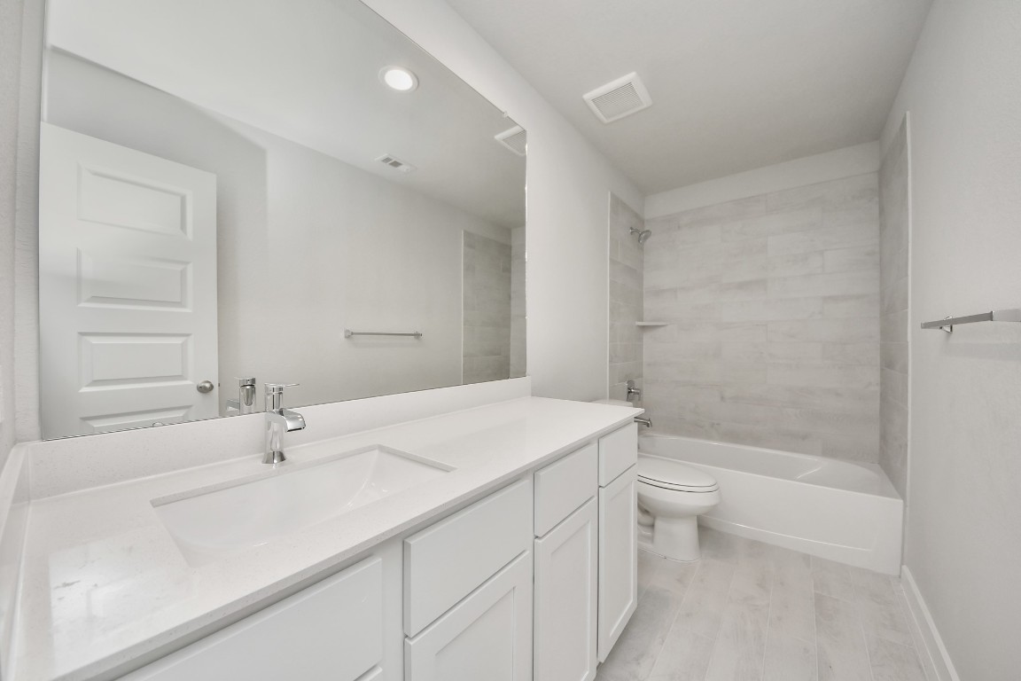 15707 Telge Ridge Lane Cypress, TX 77429 - Photo 6 of 38 a bathroom with a sink a toilet and shower