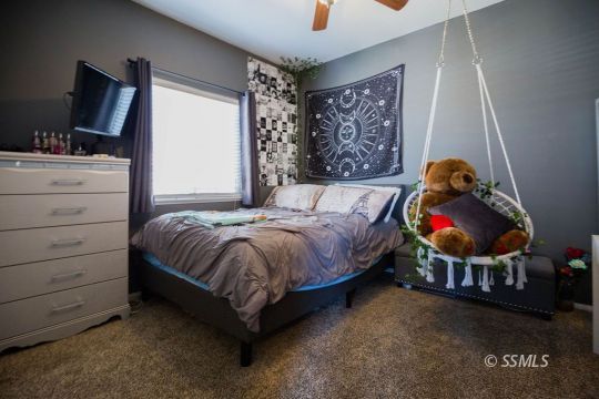408 Acacia Street Ridgecrest, CA 93555 - Photo 25 of 32 a bed sitting in a bedroom next to a window