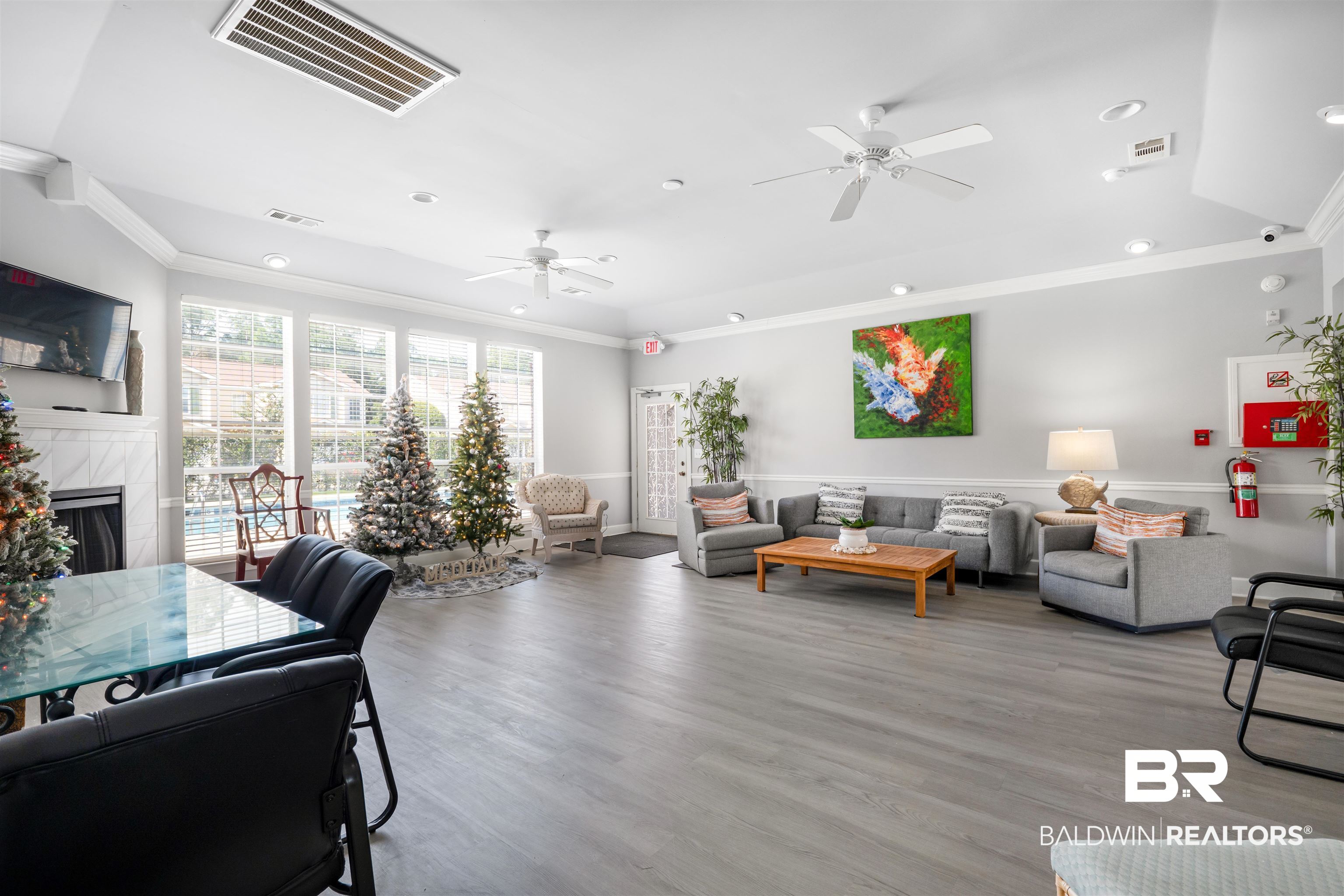 1517 Regency Road, Unit 68 Gulf Shores, AL 36542 - Photo 37 of 43 Living room with crown molding, a fireplace, ceiling fan, and light hardwood / wood-style floors