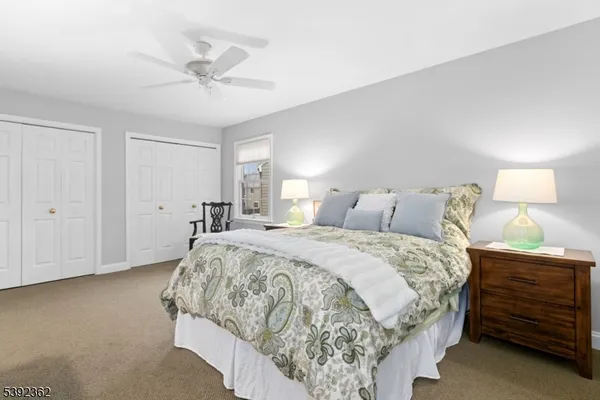 a spacious bedroom with a bed and cabinet