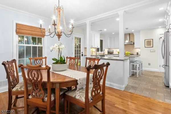 a view of a dining room with furniture and a chandelier