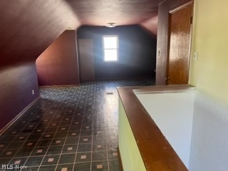 13210 Rockside Road Garfield Heights, OH 44125 - Photo 12 of 15 Bonus room with vaulted ceiling and dark tile flooring