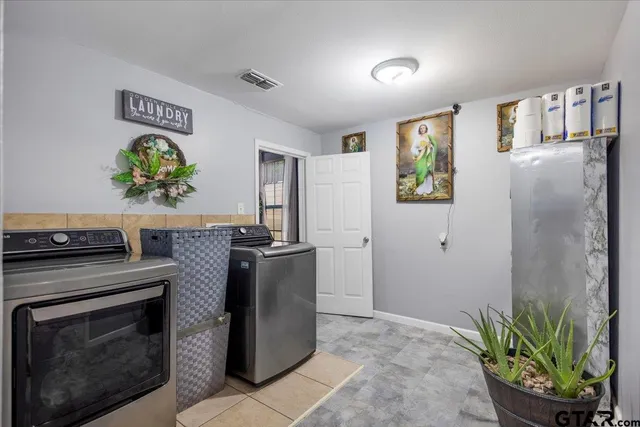 a kitchen with stainless steel appliances a refrigerator a stove a sink a counter space and cabinets