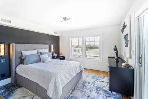 a bedroom with a large bed and a window