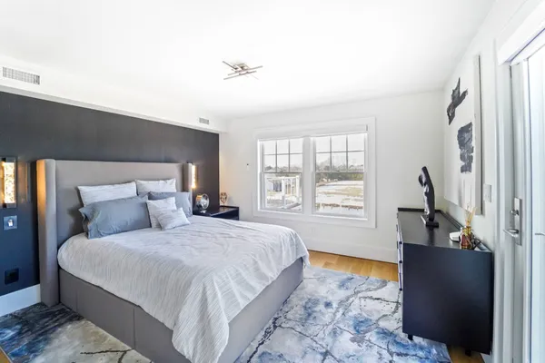 a bedroom with a large bed and a window