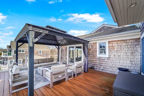 a room with wooden floor and windows