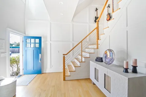 a living room with furniture wooden floor and window