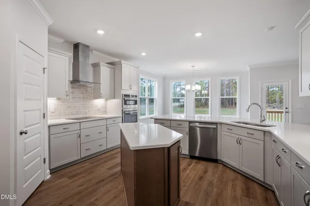 a view of empty room with wooden floor and fireplace