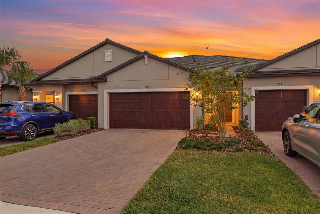 a front view of a house with a yard and garage