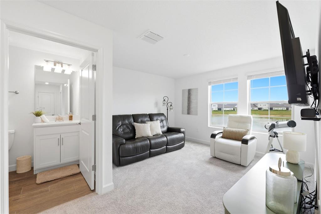 10799 Gable Dig Loop San Antonio, FL 33576 - Photo 13 of 19 a living room with furniture and a flat screen tv