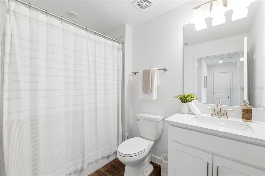 10799 Gable Dig Loop San Antonio, FL 33576 - Photo 14 of 19 a bathroom with a sink a toilet and a mirror