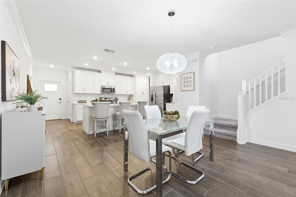 10799 Gable Dig Loop San Antonio, FL 33576 - Photo 7 of 19 a view of a dining room with furniture and wooden floor