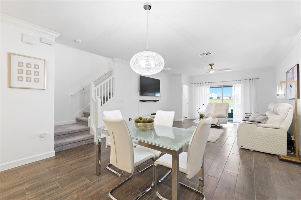 10799 Gable Dig Loop San Antonio, FL 33576 - Photo 8 of 19 a view of a dining room with furniture and wooden floor