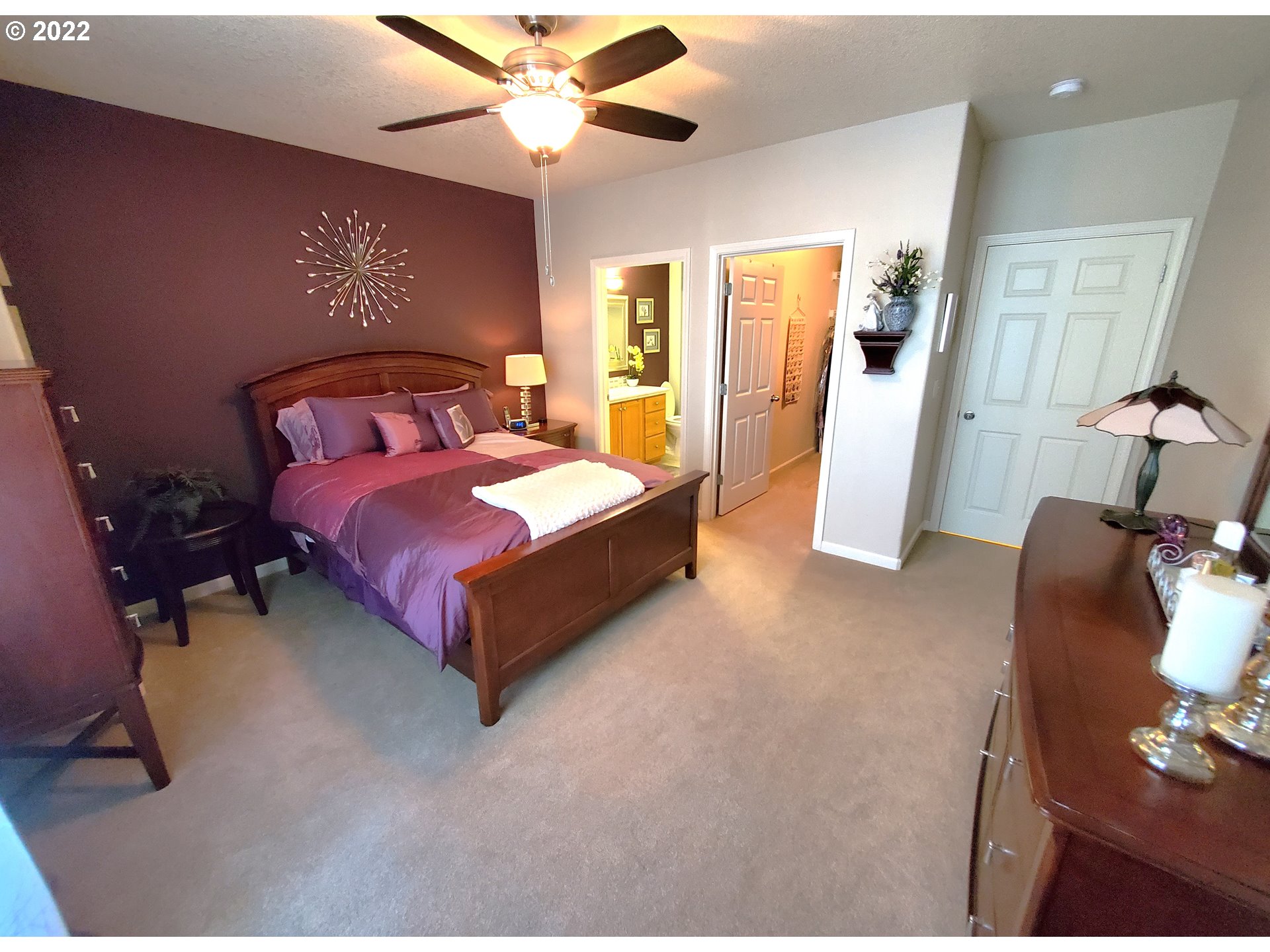 4520 Southwest 11th Street Gresham, OR 97080 - Photo 18 of 30 a spacious bedroom with a bed and a chandelier