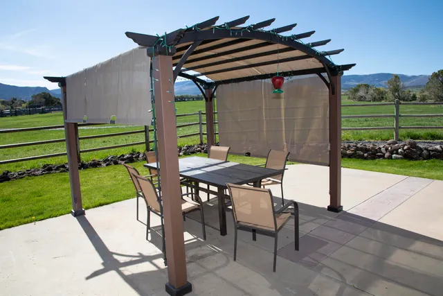 a backyard of a house with a garden and outdoor seating