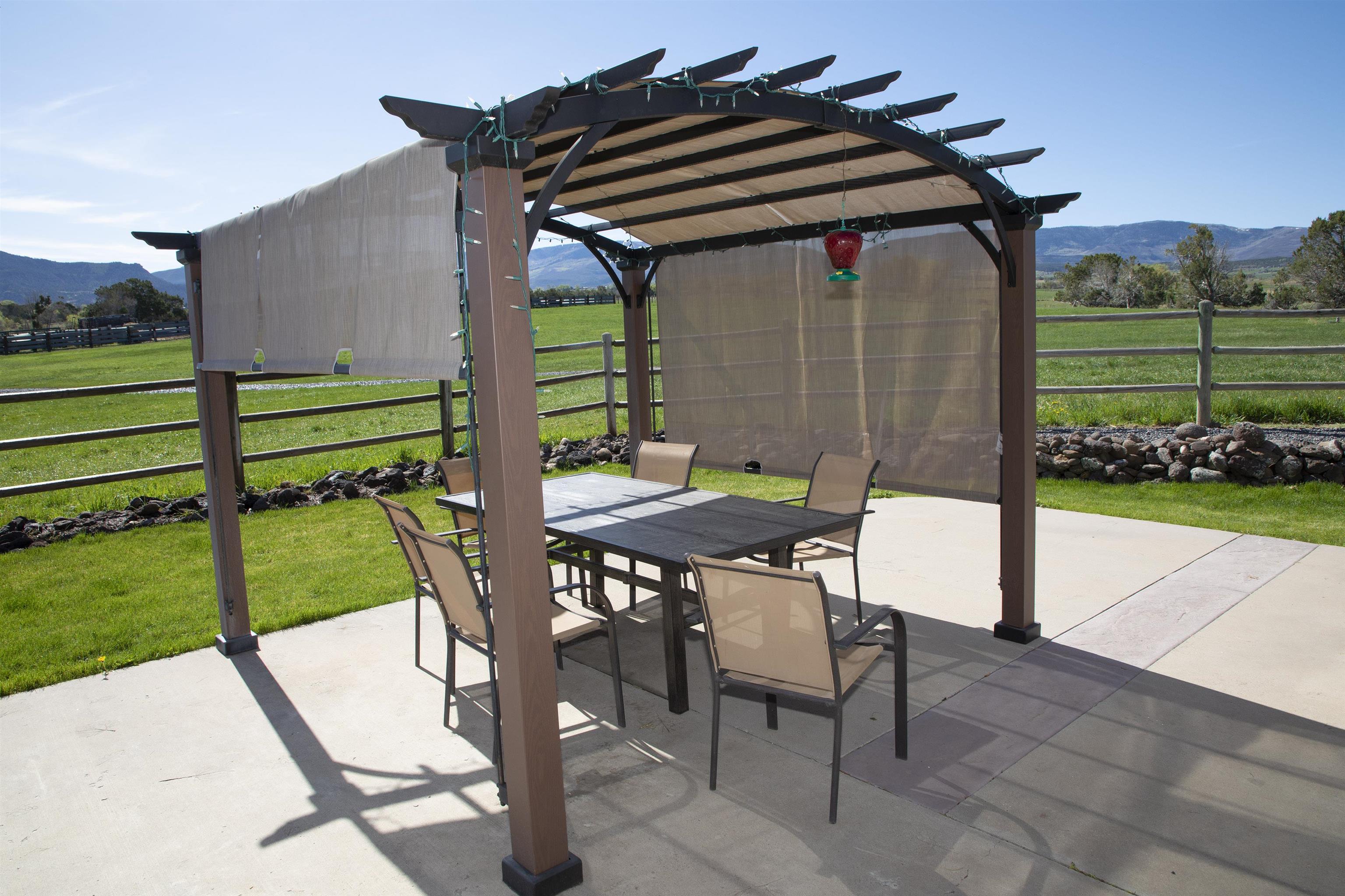 57178 Oe Road Collbran, CO 81624 - Photo 12 of 41 a backyard of a house with a garden and outdoor seating