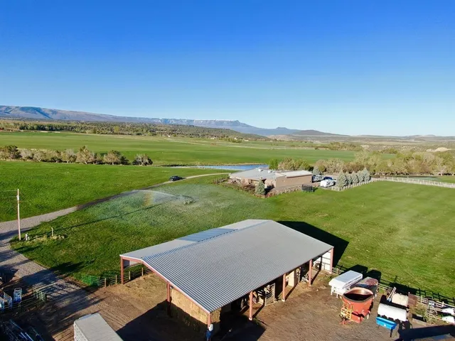 an aerial view of a house with big yard