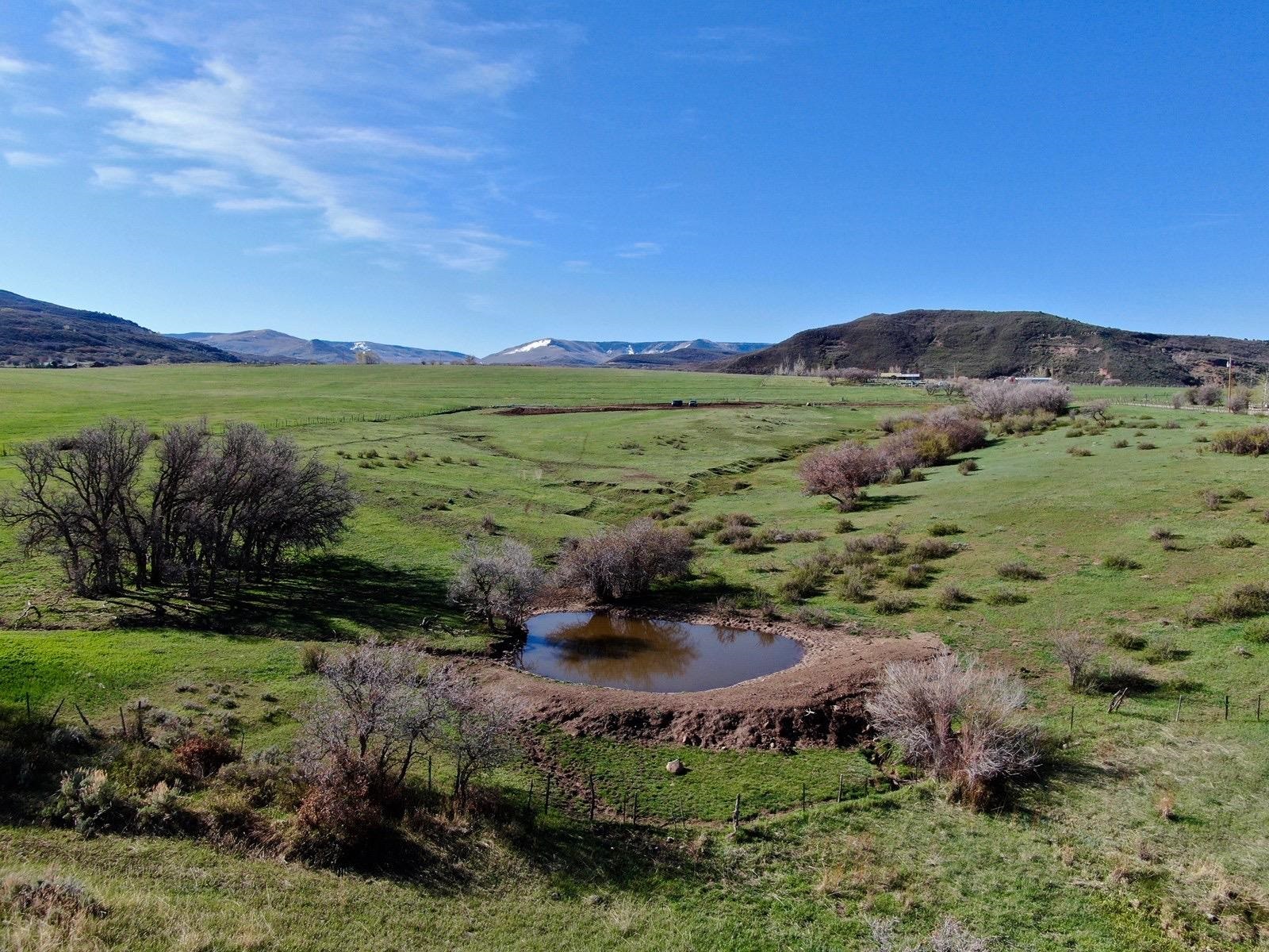57178 Oe Road Collbran, CO 81624 - Photo 21 of 41 a view of a lake with a mountain in the background