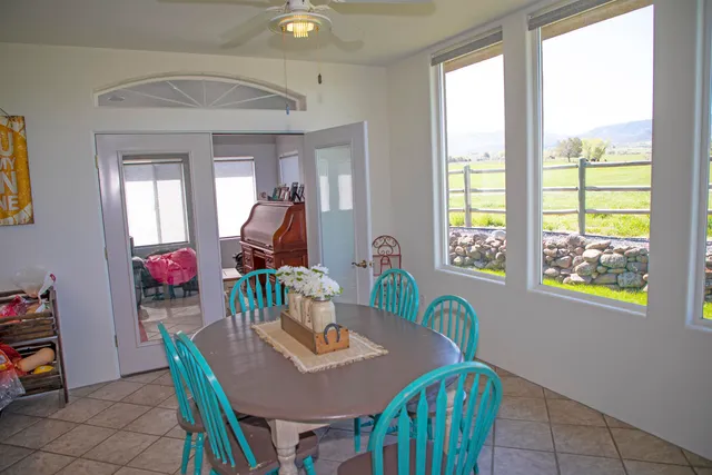 a dining room with furniture and wooden floor