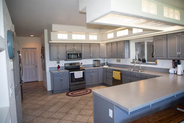 a kitchen with sink a refrigerator and cabinets