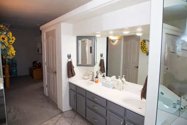 a bathroom with a double vanity sink a and mirror