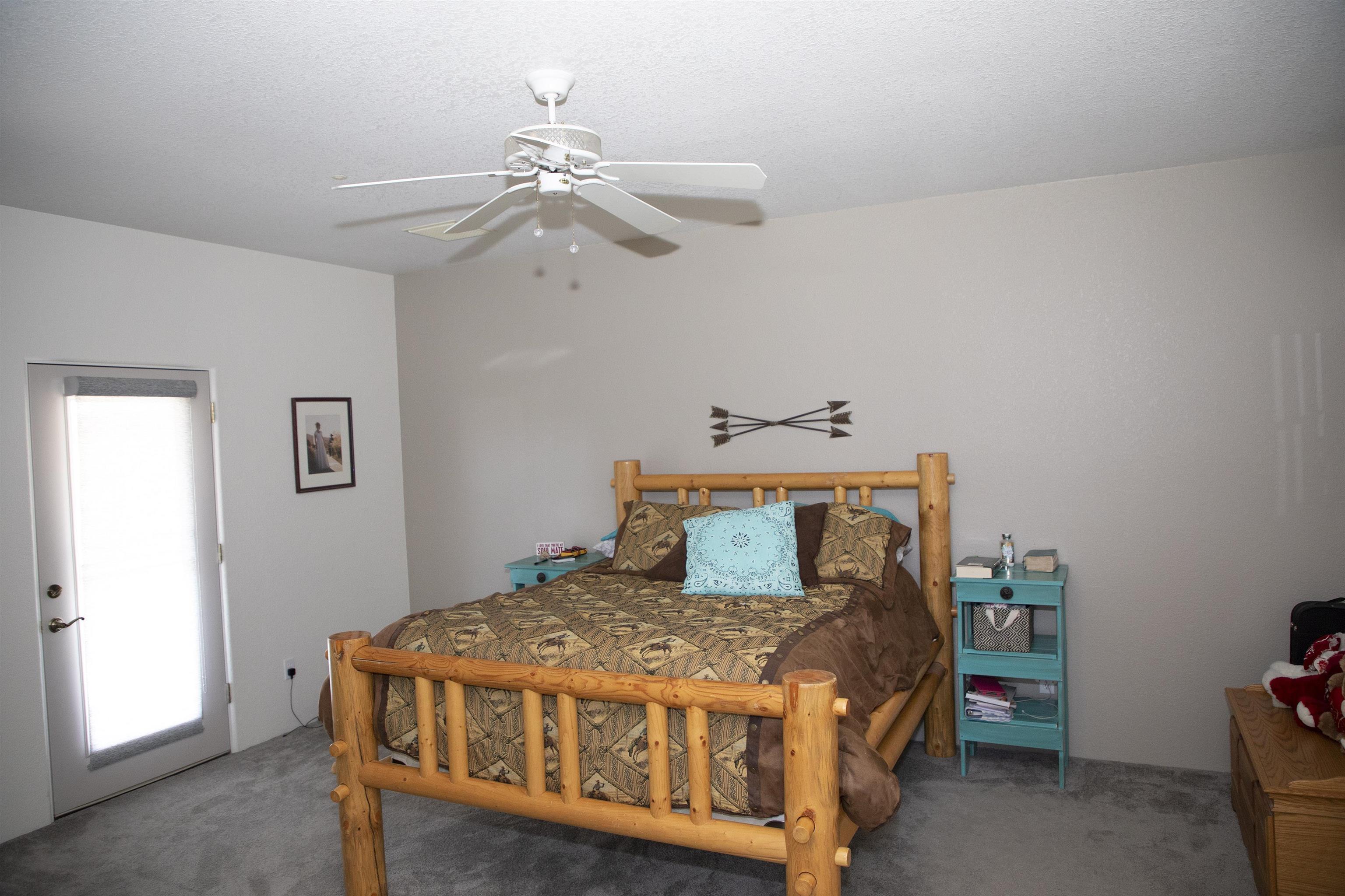 57178 Oe Road Collbran, CO 81624 - Photo 39 of 41 a bedroom with a bed and a chandelier