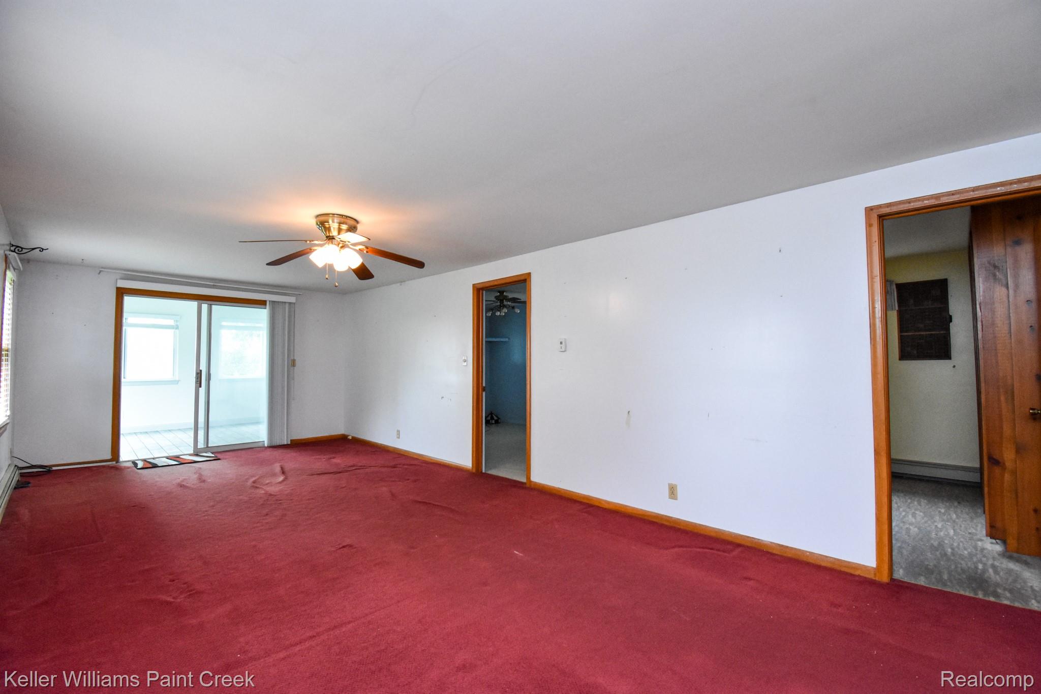 6533 River Road Marine City, MI 48039 - Photo 6 of 17 Spare room with carpet floors, ceiling fan, and a baseboard radiator