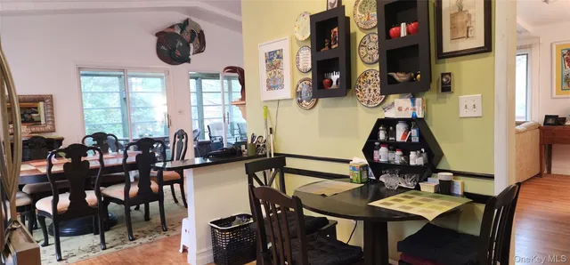 a view of a dining room with furniture and a chandelier