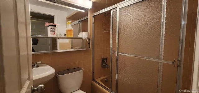 a bathroom with a toilet a sink and shower