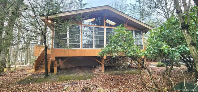 a view of a chair and table in backyard of the house