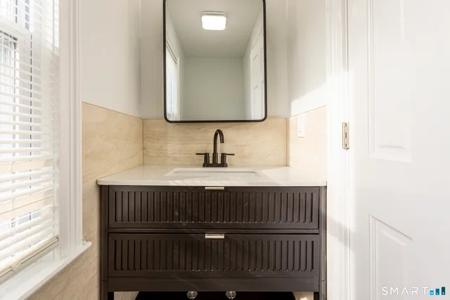 a bathroom with a sink and a mirror
