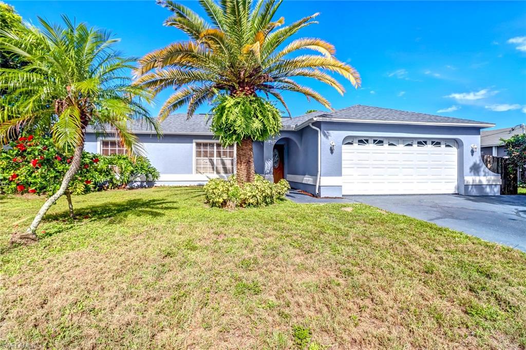 18250 Maple Road Fort Myers, FL 33967 - Photo 1 of 26 a front view of a house with garden