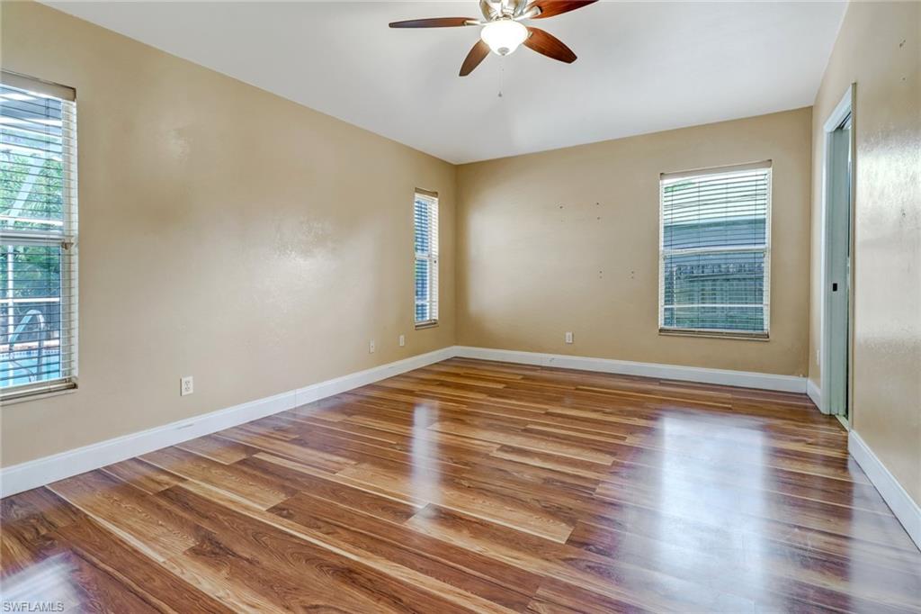 18250 Maple Road Fort Myers, FL 33967 - Photo 12 of 26 a view of empty room with wooden floor and fan