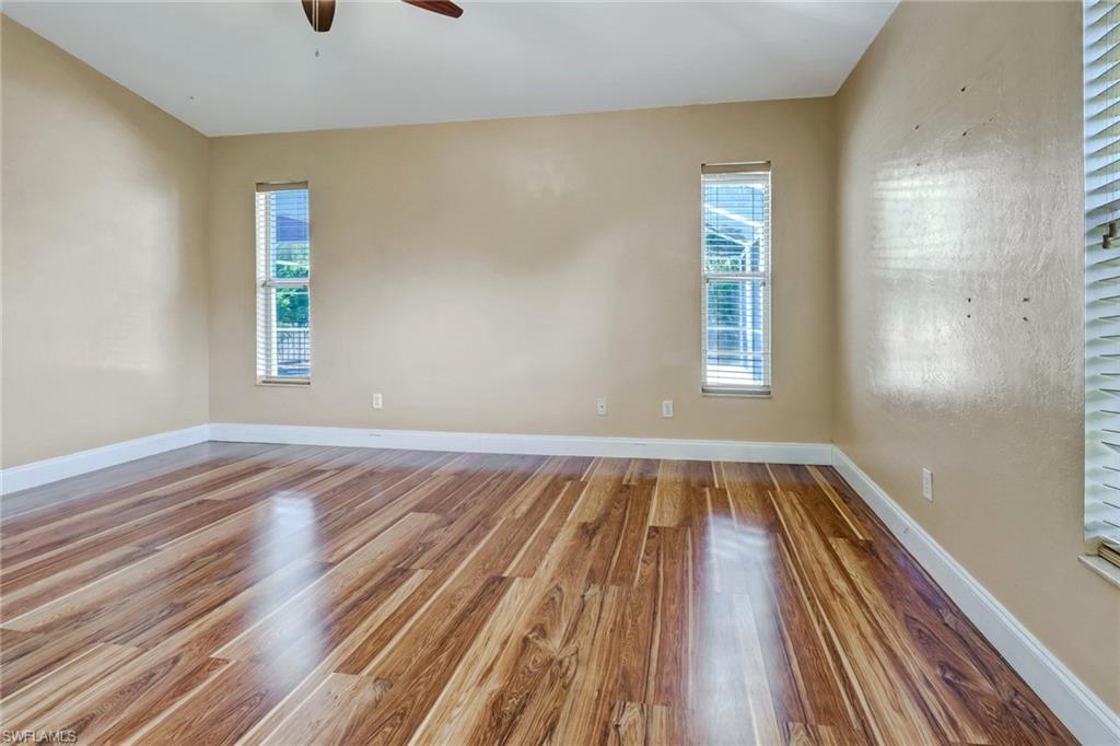 18250 Maple Road Fort Myers, FL 33967 - Photo 13 of 26 a view of an empty room with wooden floor and a window