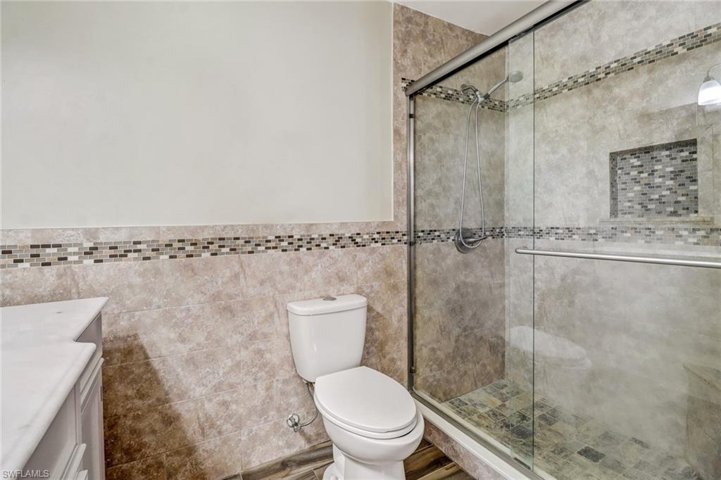 18250 Maple Road Fort Myers, FL 33967 - Photo 15 of 26 a white toilet sitting next to a shower