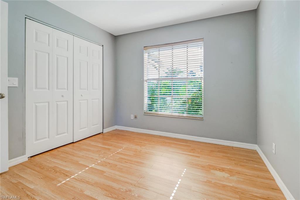 18250 Maple Road Fort Myers, FL 33967 - Photo 17 of 26 a view of an empty room with wooden floor and a window