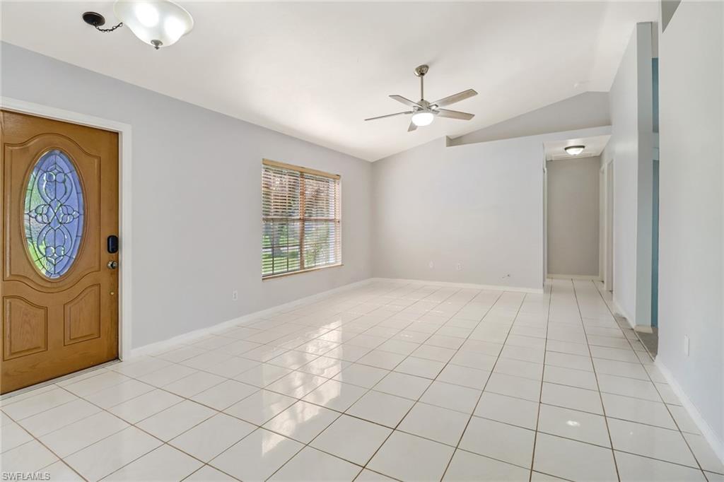 18250 Maple Road Fort Myers, FL 33967 - Photo 2 of 26 an empty room with windows and fan