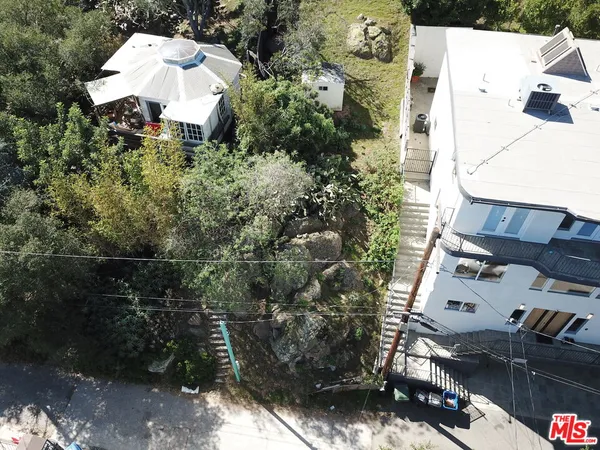 an aerial view of a house with a yard