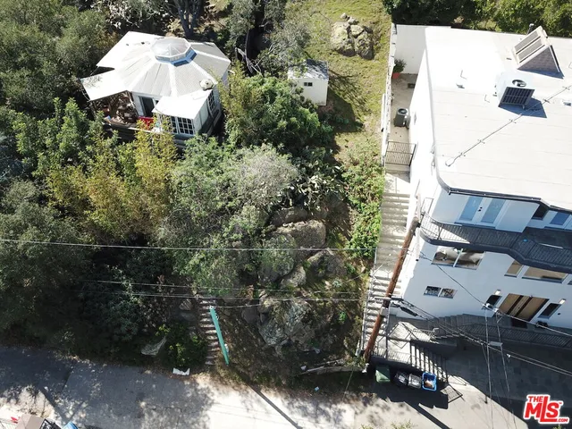 an aerial view of a house with a yard