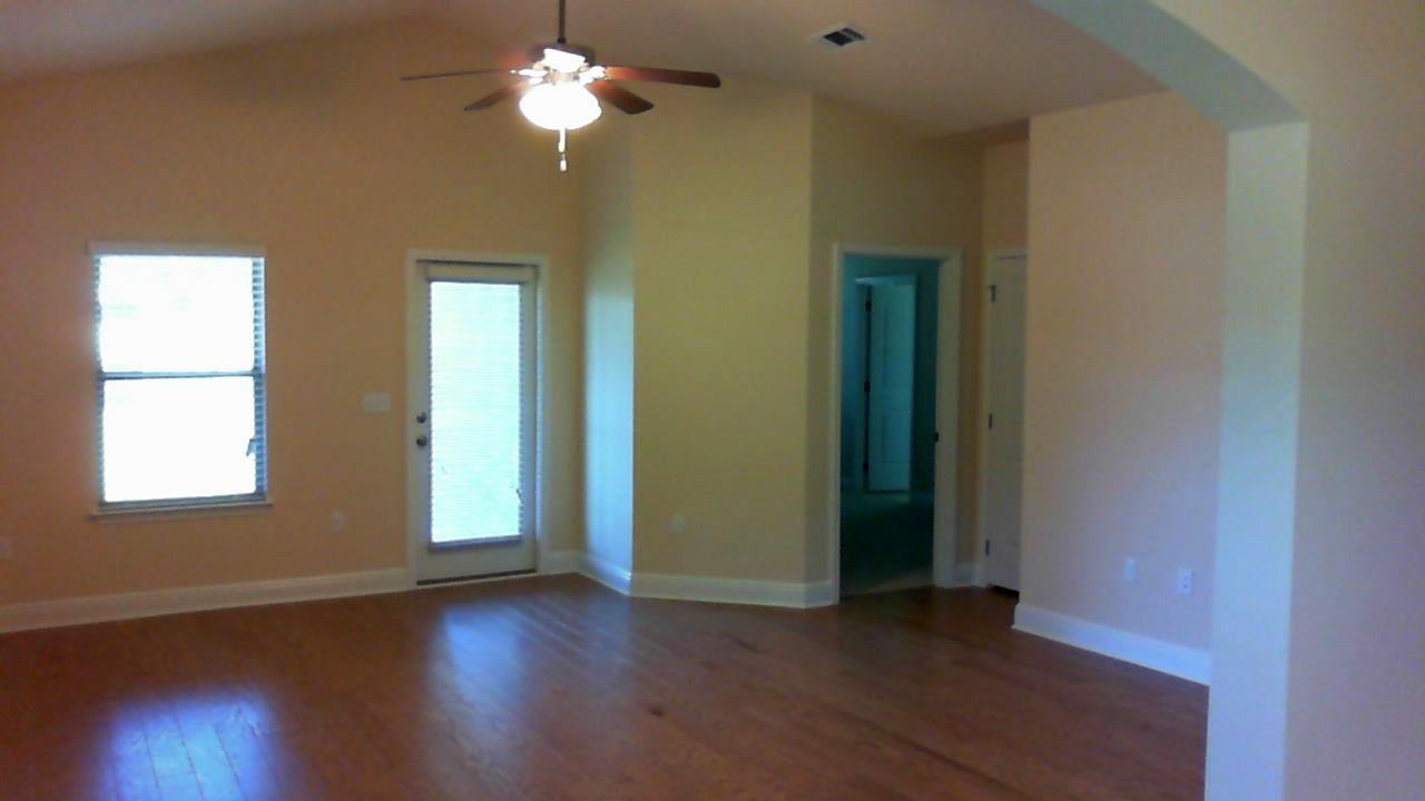 41 Twain Trail Freeport, FL 32439 - Photo 9 of 19 a view of empty room with wooden floor and fan